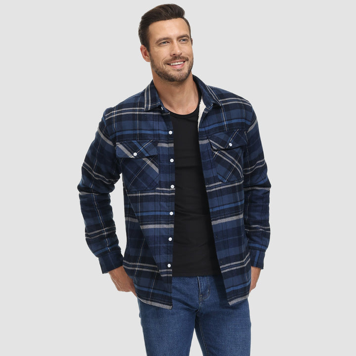 Close-up of the chest pocket detail on a men's fleece lined flannel button-down jacket, functional design