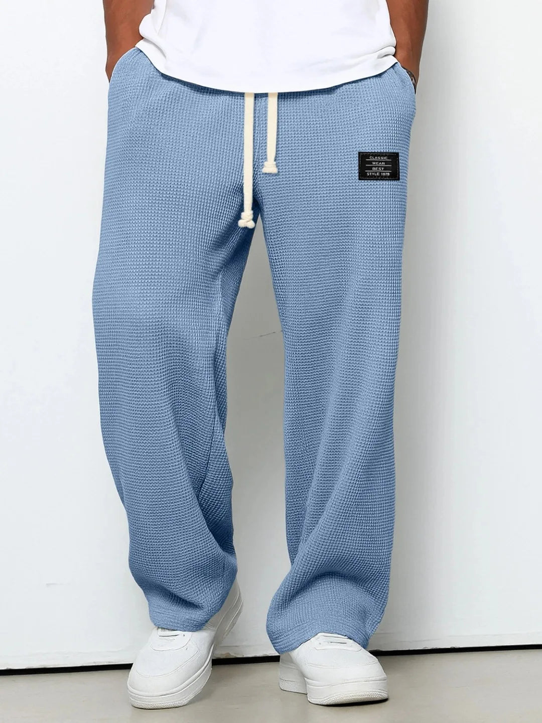 Men's relaxed fit blue lounge pants, waffle knit for ultimate comfort & everyday casual style. Drawstring waist.