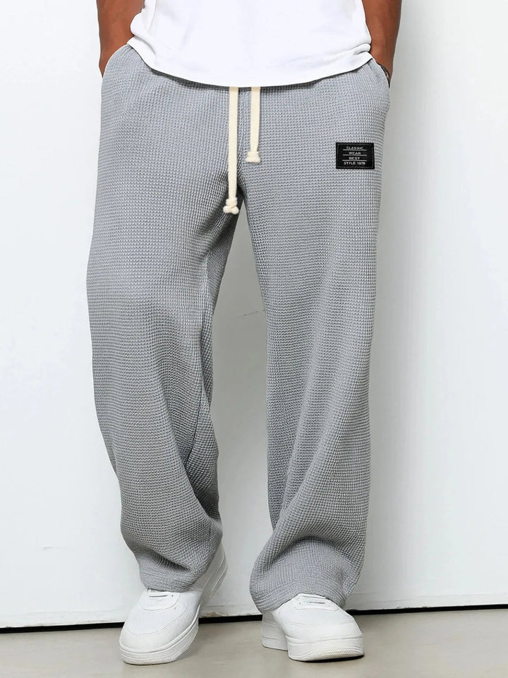 Men's relaxed fit casual lounge trousers in a soft waffle knit, perfect for everyday comfort & relaxation.