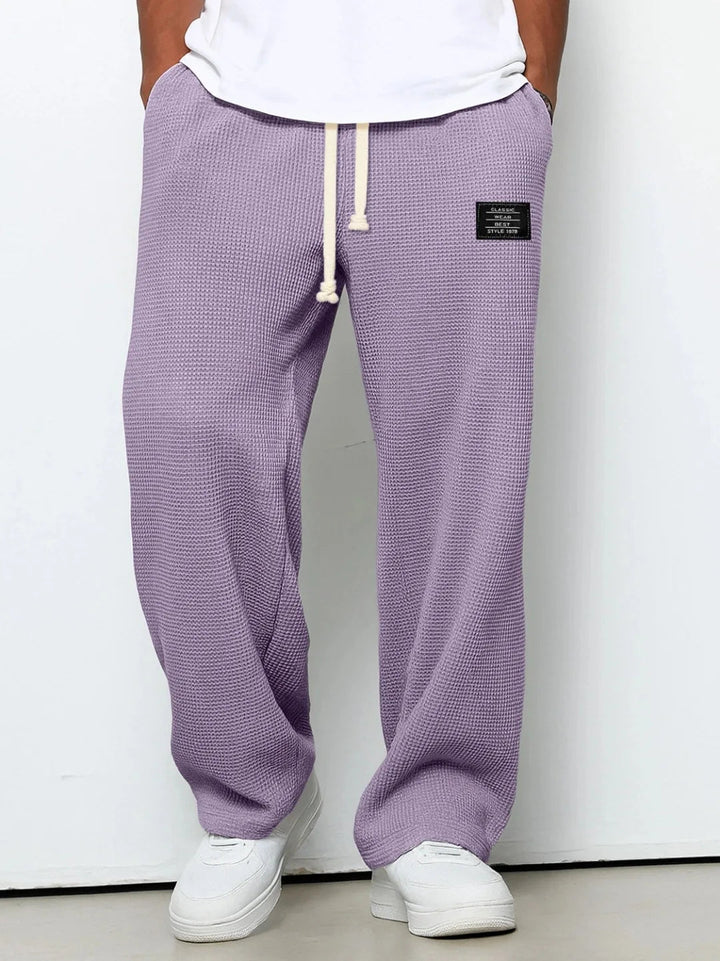 Versatile men's blue chino lounge pants with relaxed fit, waffle knit & drawstring for casual comfort wear.