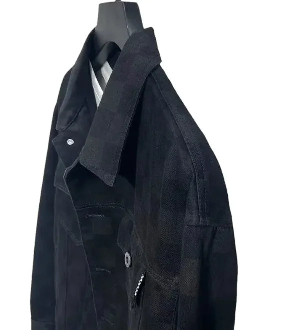 Close-up of a men's checkered denim jacket, highlighting the fabric texture and relaxed fit.