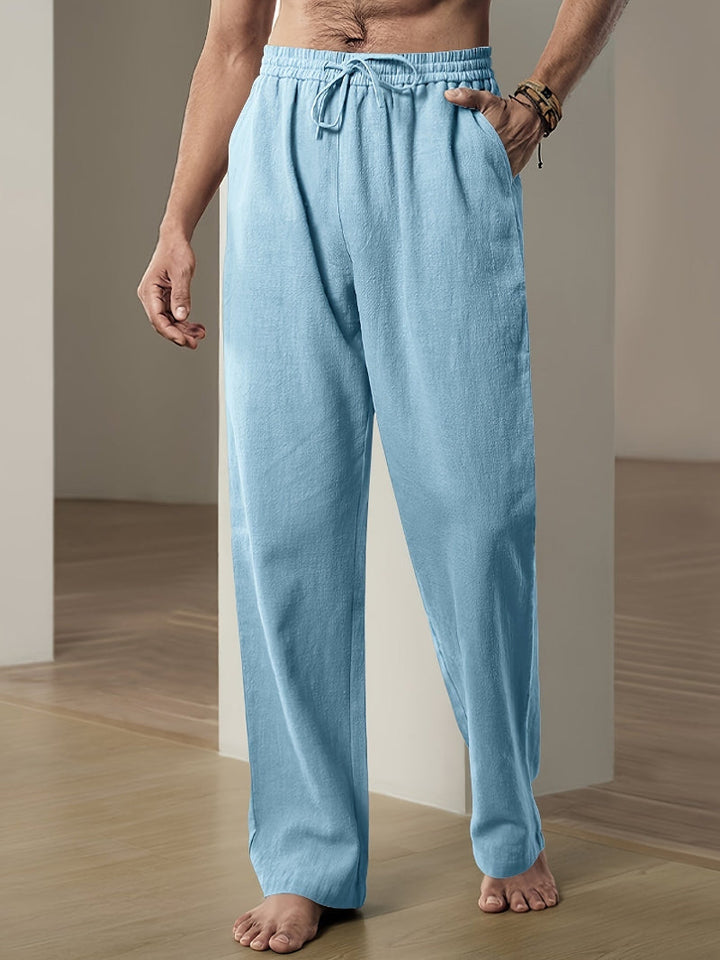 Man wearing casual men's relaxed fit drawstring pants, suitable for a comfortable everyday look.