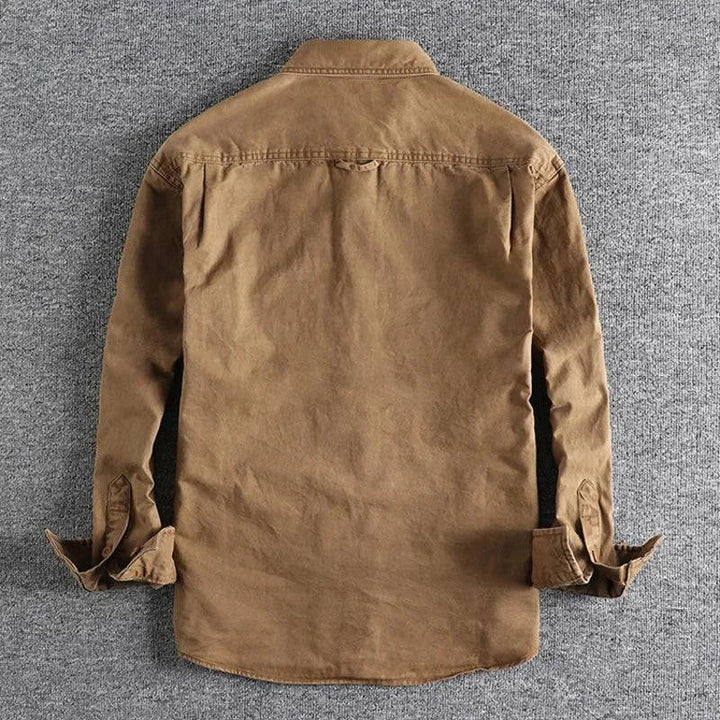 Close-up of Olive men's durable field shirt fabric, showcasing rugged texture & quality button details.
