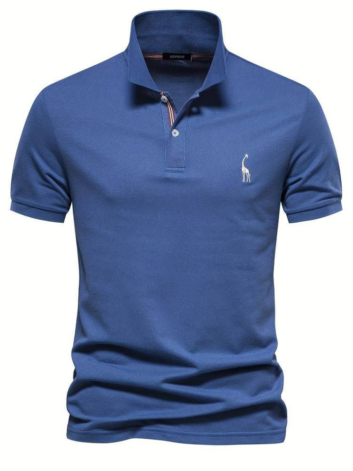 Close-up of men's comfort fit polo shirt showing embroidered playful giraffe design on chest. Ideal for golf.