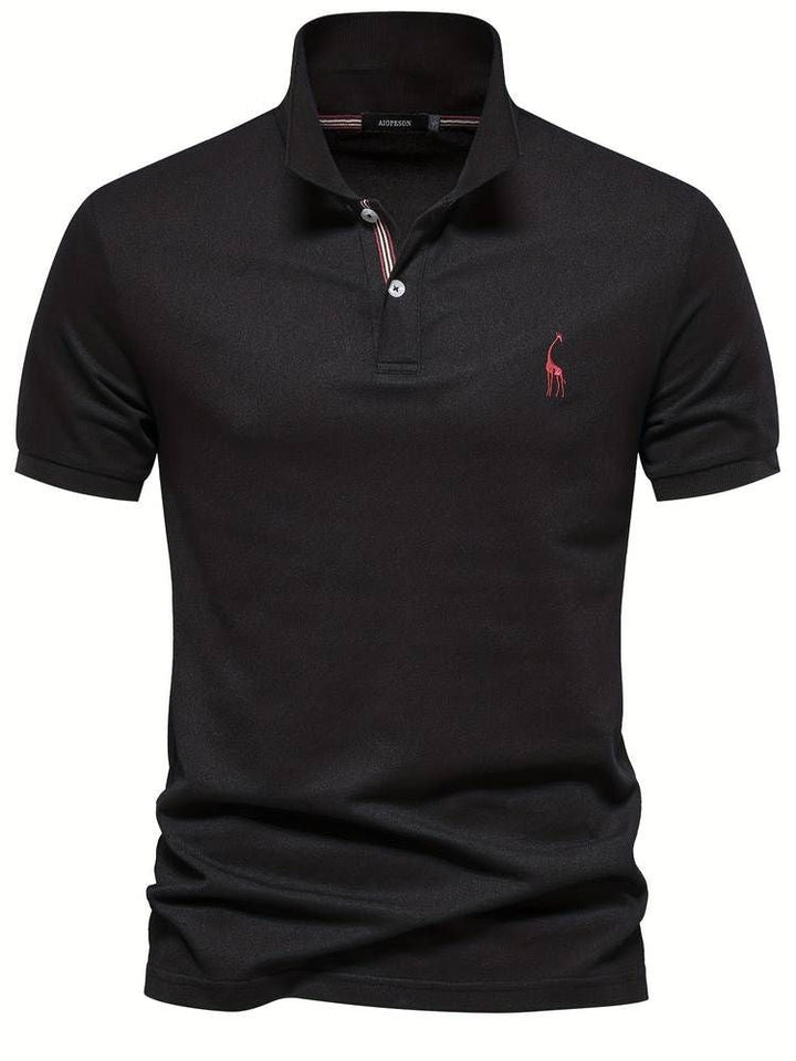 Man wearing a men's short sleeve golf polo shirt with a playful embroidered giraffe, swinging a golf club.