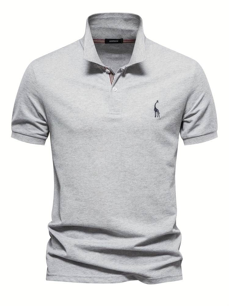 Detail of the embroidered playful giraffe on a men's short sleeve golf polo shirt, highlighting quality and design.