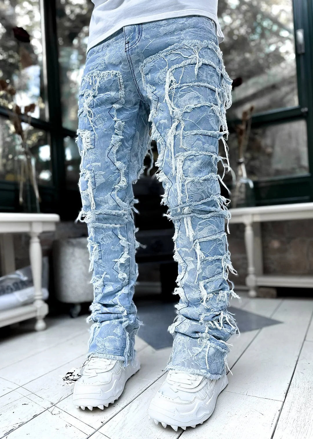 Men's slim fit distressed ripped jeans for urban style. Modern denim pants with tears & patches, perfect for street fashion.
