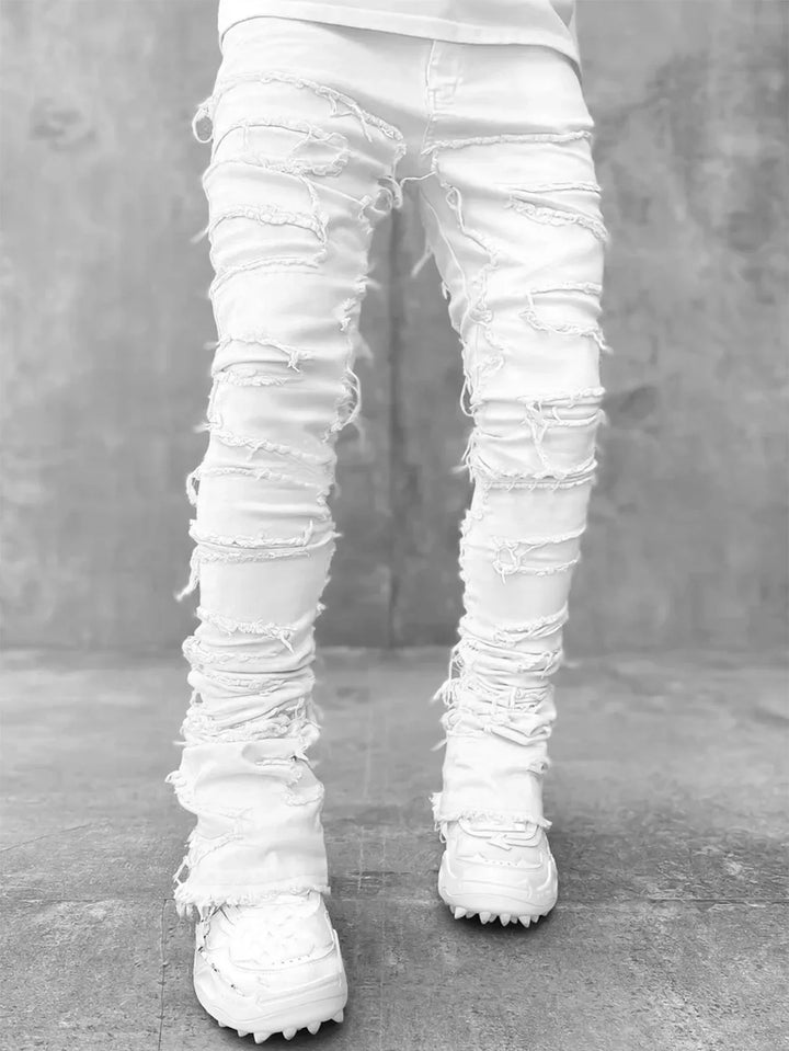 Fashionable men's distressed ripped jeans in a slim fit. Stylish denim pants for a modern urban street wear look.