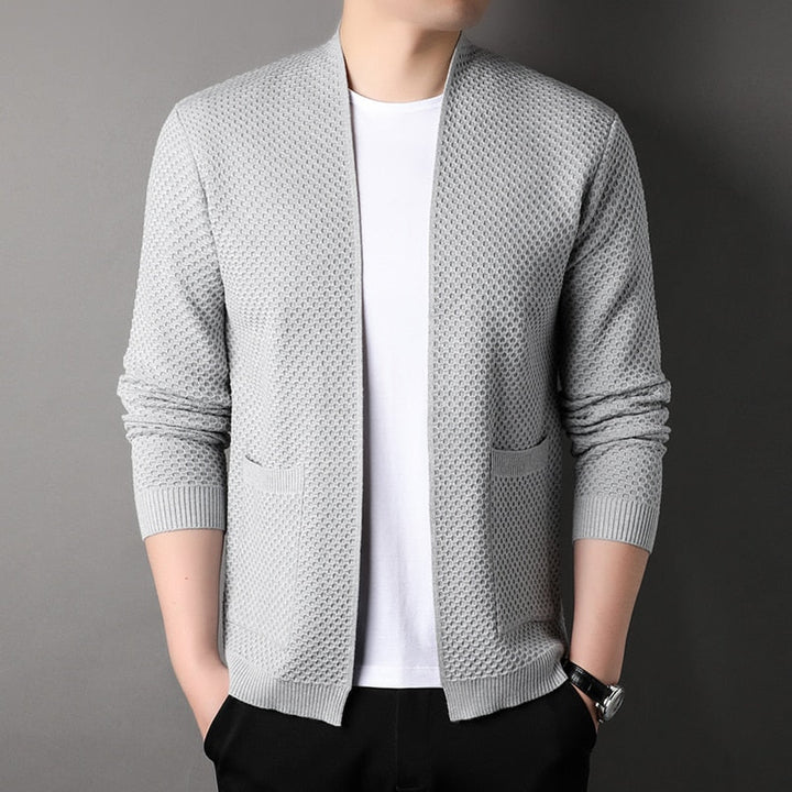 Close-up of a men's slim fit knitted cardigan showing texture and functional front pockets.