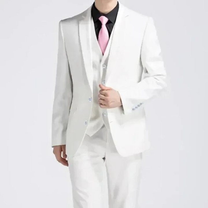 Man posing in a stylish three-piece suit, showcasing spring/summer formal wear and tailoring
