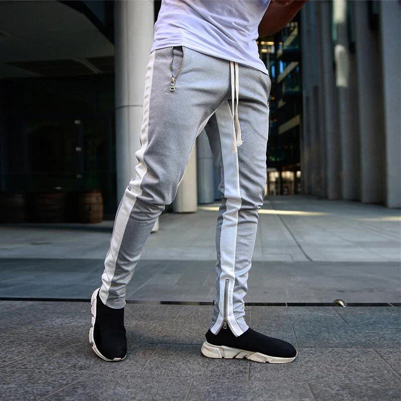 Men's slim fit track sweatpants, ideal for athletic wear, featuring a stylish zip hem for easy wear and comfort.