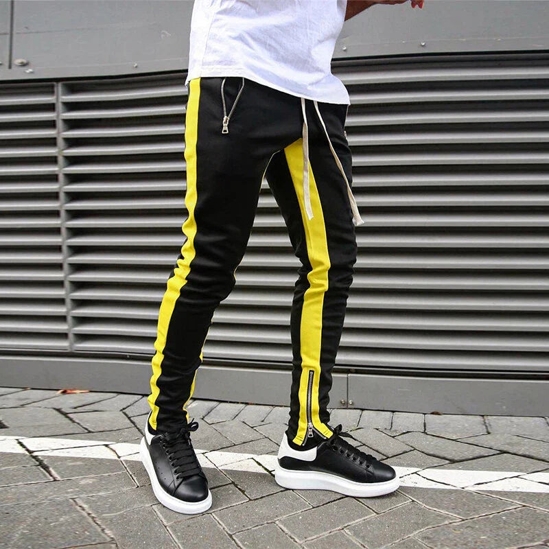 Trendy men's slim fit track joggers, designed for performance & style, featuring a functional zip hem detail.