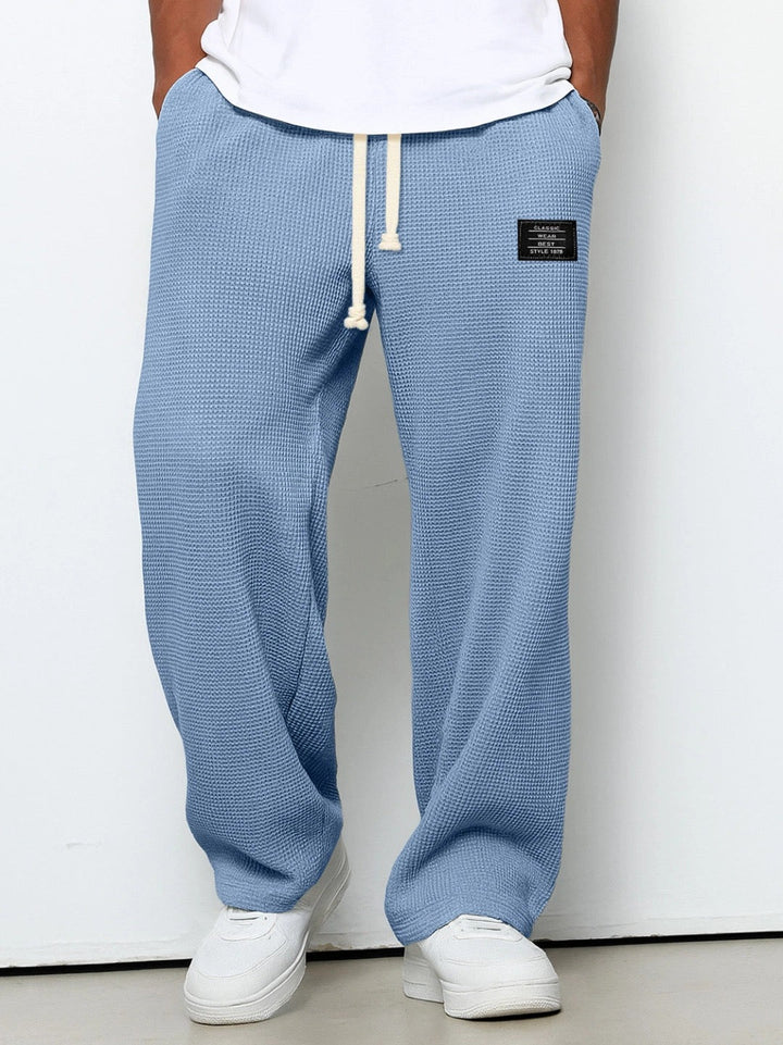 Close-up of Stuart men's casual chino pants featuring a functional drawstring for a custom, loose fit.