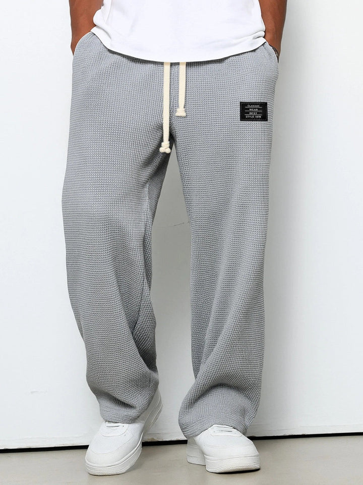 Back view of Stuart men's loose fit drawstring chino pants with practical pockets, ideal for everyday.