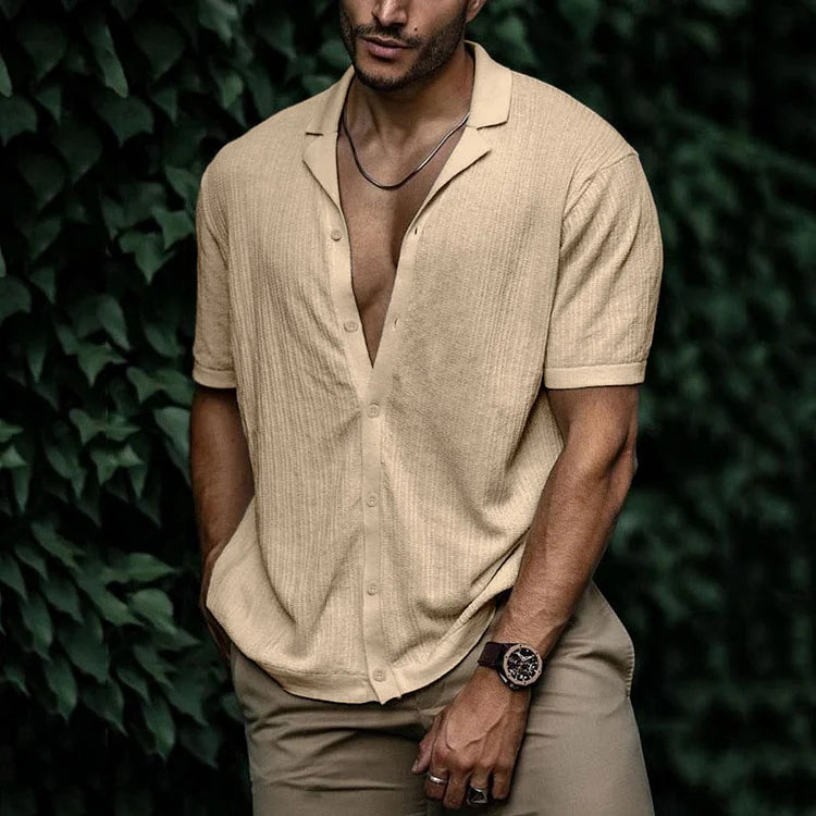 Close-up of stylish men's textured summer shirt. Features Cuban collar, short sleeves, and button-down front.