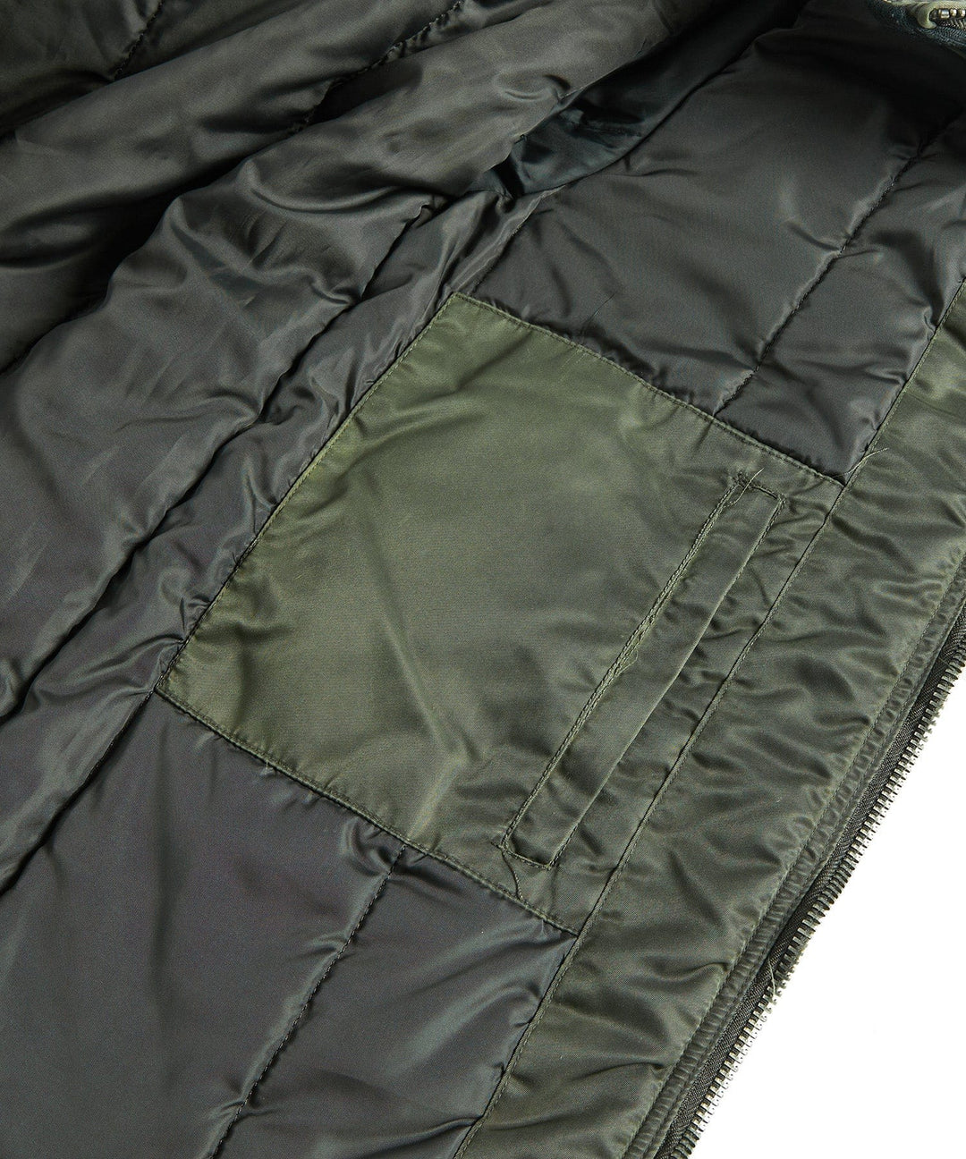 Flat lay of the men's dark green military-inspired jacket, ready for urban and outdoor adventures.