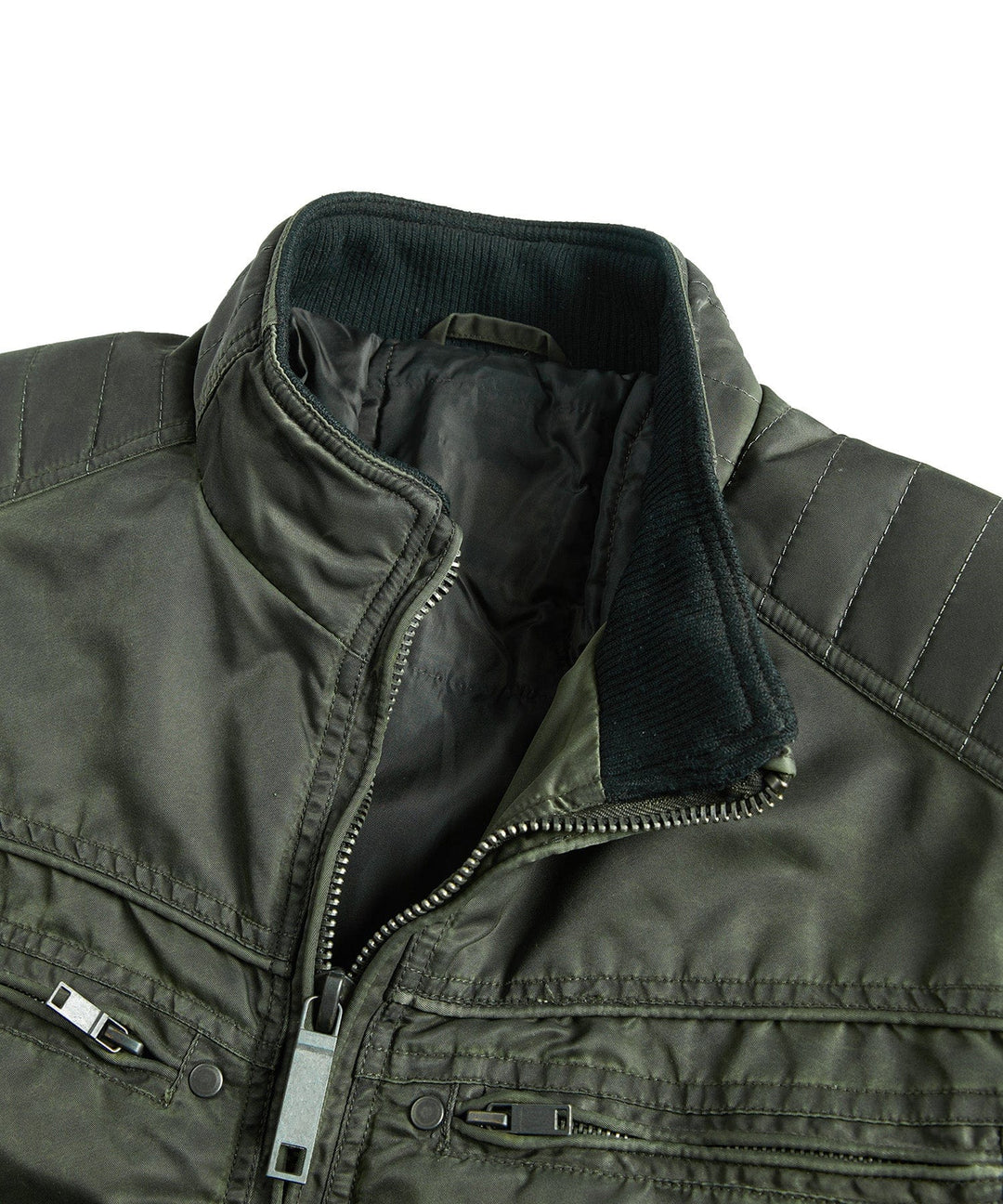Man wearing the dark green insulated military jacket, paired with jeans, in an urban setting.