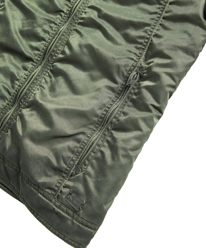 Detailed shot of the zipper and button closures on the men's urban military-style jacket.