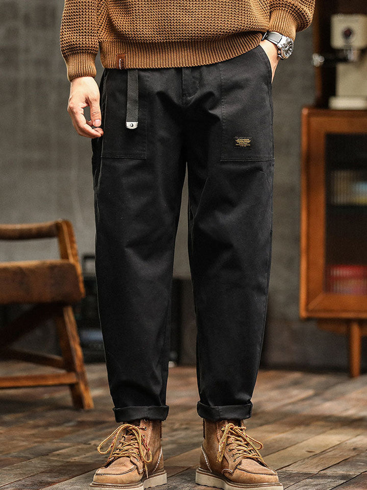 Stylish men's vintage-inspired utility pants. Navy blue relaxed fit cargo trousers for modern casual fashion.