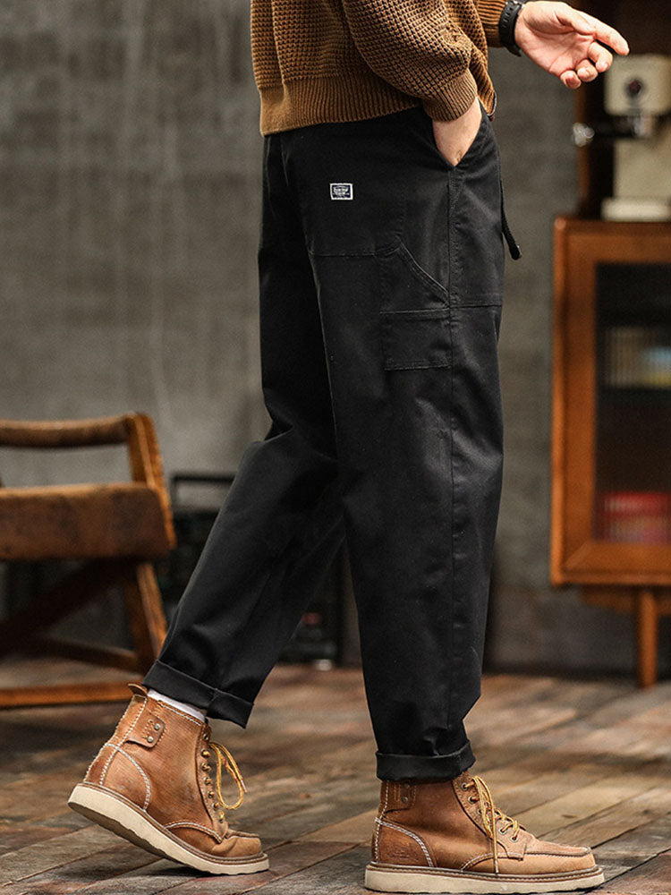 Khaki men's relaxed fit utility pants. Vintage-inspired design, comfortable for casual and workwear.