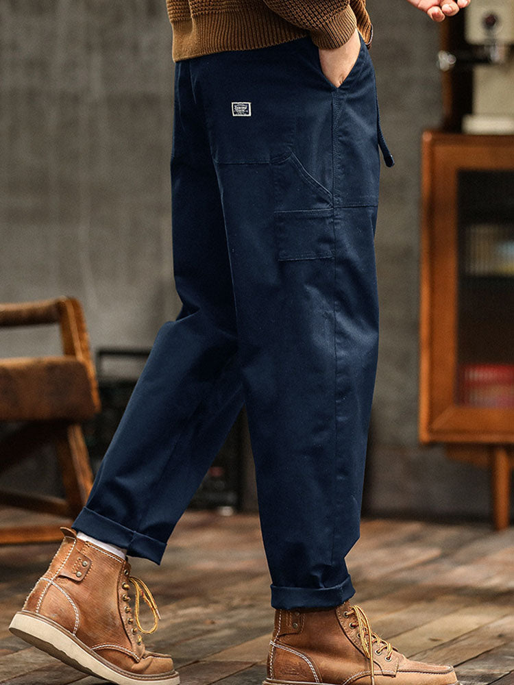 Black men's relaxed fit cargo pants. Vintage utility style, perfect for comfortable outdoor fashion.