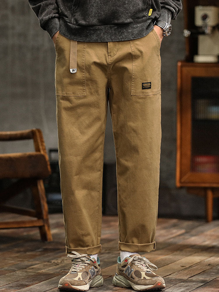 Khaki men's vintage utility pants. Relaxed fit cargo trousers, perfect for casual or workwear.