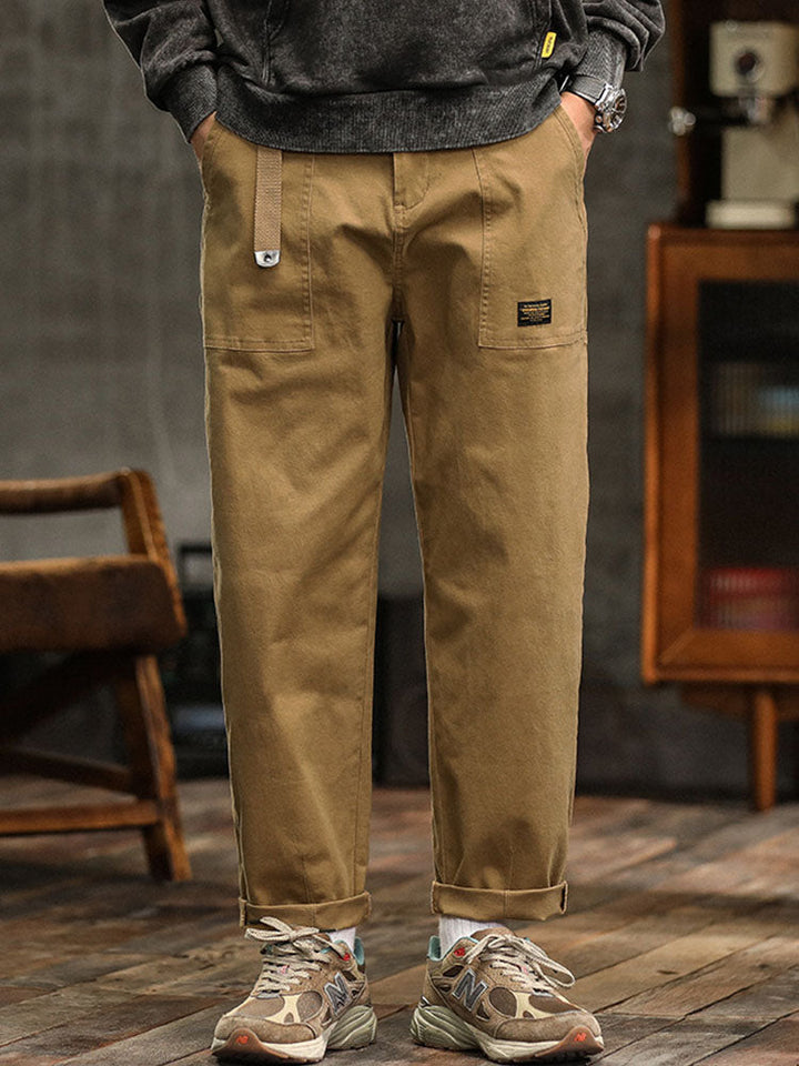 Khaki men's vintage utility pants. Relaxed fit cargo trousers, perfect for casual or workwear.