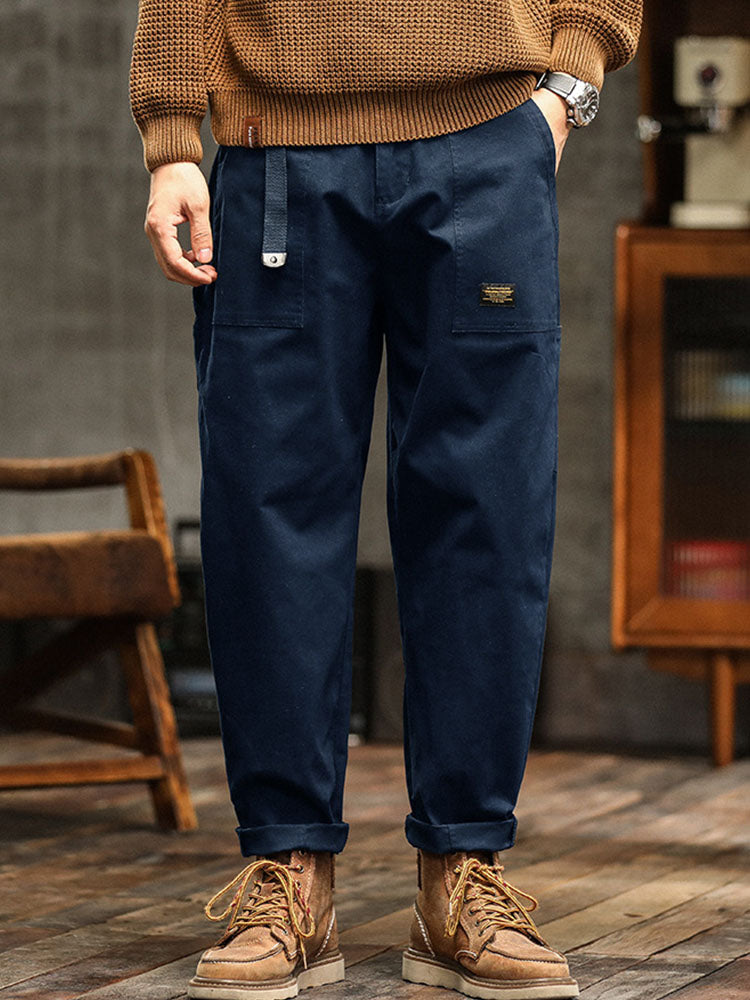 Army green men's vintage workwear utility pants. Relaxed fit, ideal for outdoor & casual fashion.