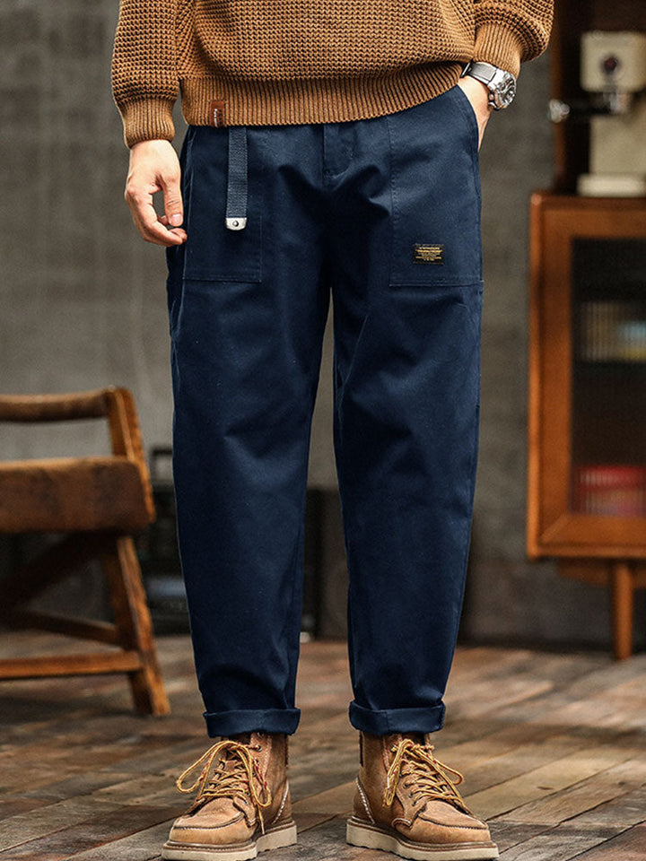 Army green men's vintage workwear utility pants. Relaxed fit, ideal for outdoor & casual fashion.