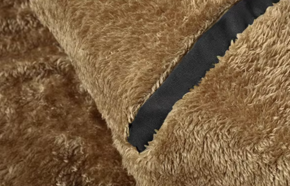 Folded men's winter coat, showing its thick fur lining, ready for cold weather and outdoor wear.
