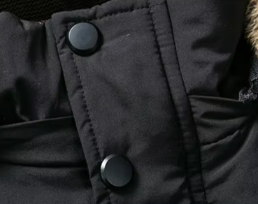 Men's jacket in a snowy landscape, emphasizing its heavy-duty and warm features for cold weather.