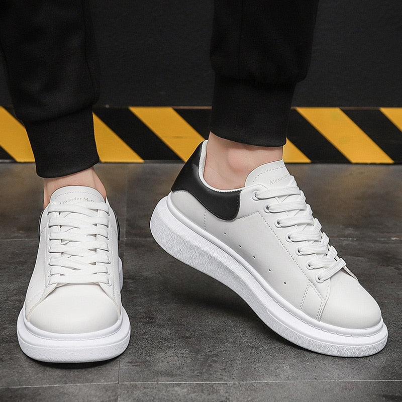 Men's white platform casual sneakers with lace-up closure for everyday comfort and modern streetwear style.