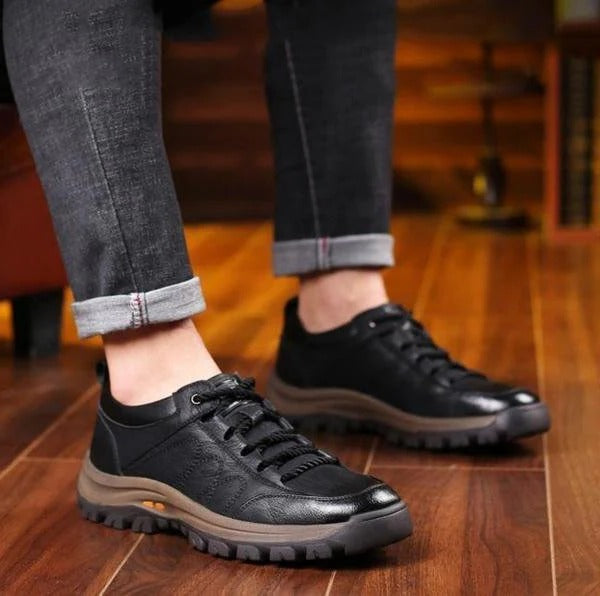 Lifestyle image of a man wearing brown orthopedic shoes for outdoor activities.