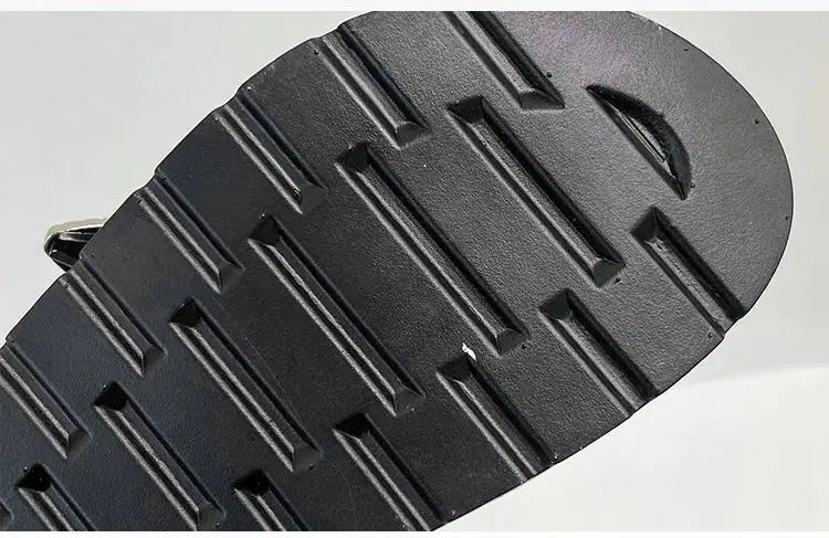 Side view of women's studded platform sandals, showcasing the bold silhouette & punk style.