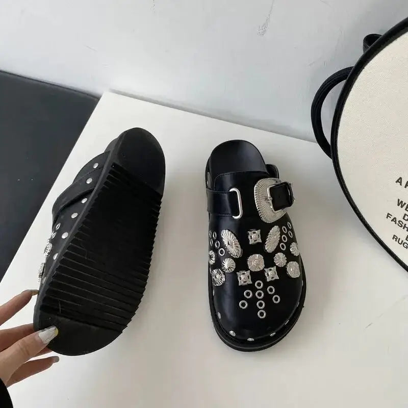 Close-up of black studded platform sandals for women, showcasing punk style detailing.