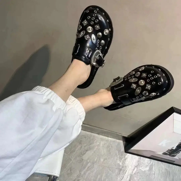 High-angle view of black studded platform sandals, perfect for edgy women's summer shoes.