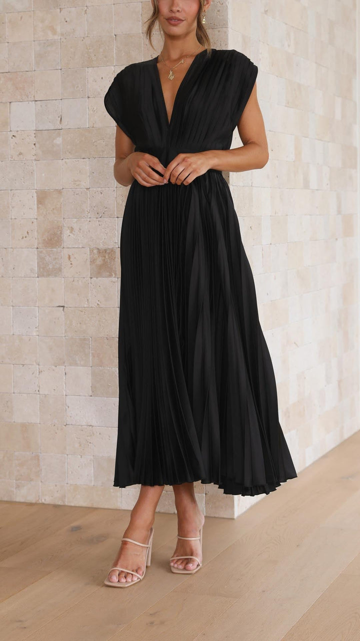 Silk pleated maxi dress with V-neck in rose red, featuring a high waist and elegant flowing pleats for a sophisticated look.