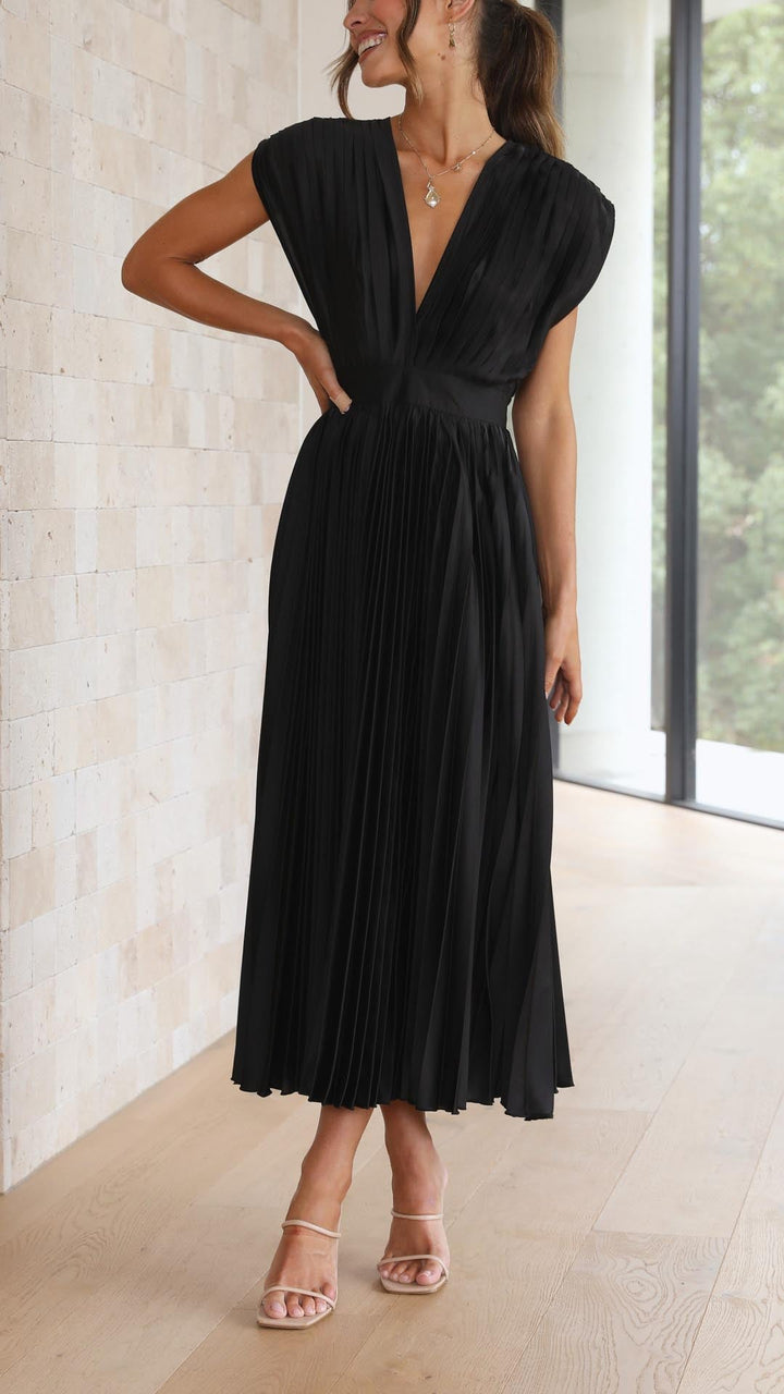 Silk pleated maxi dress with V-neck in rose red, featuring a high waist and elegant flowing pleats for a sophisticated look.