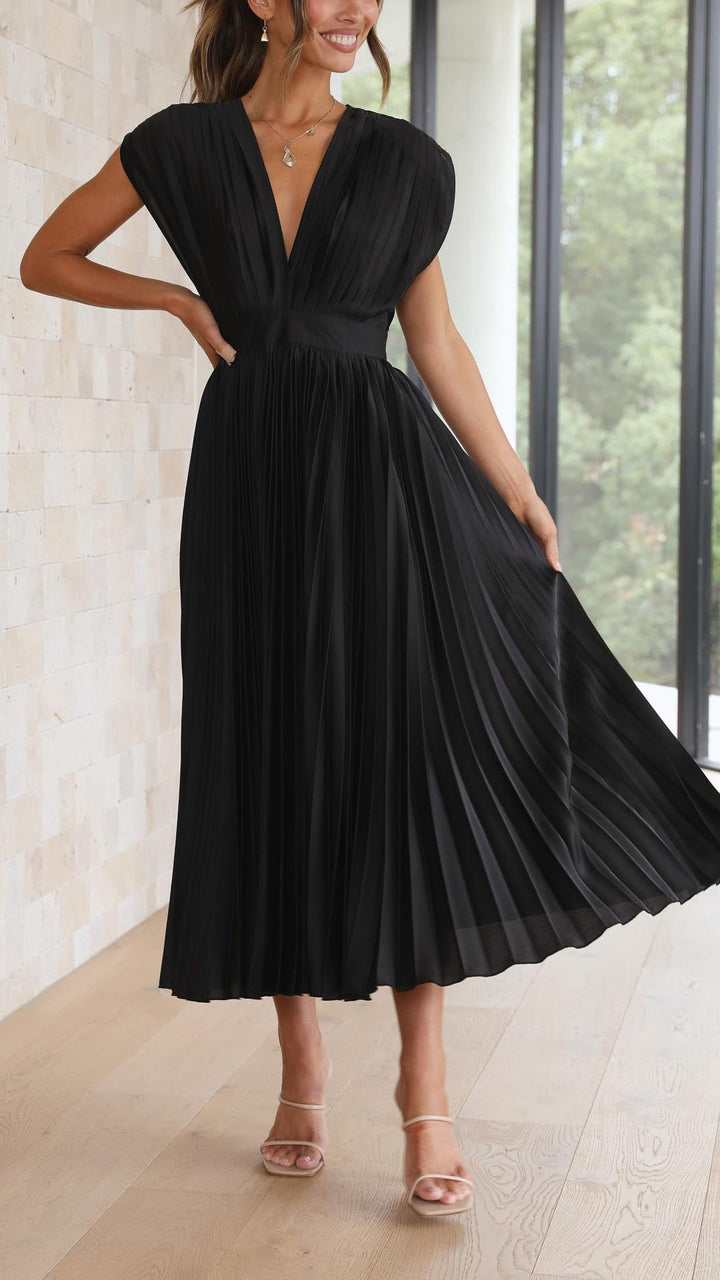 Silk pleated maxi dress with V-neck in rose red, featuring a high waist and elegant flowing pleats for a sophisticated look.