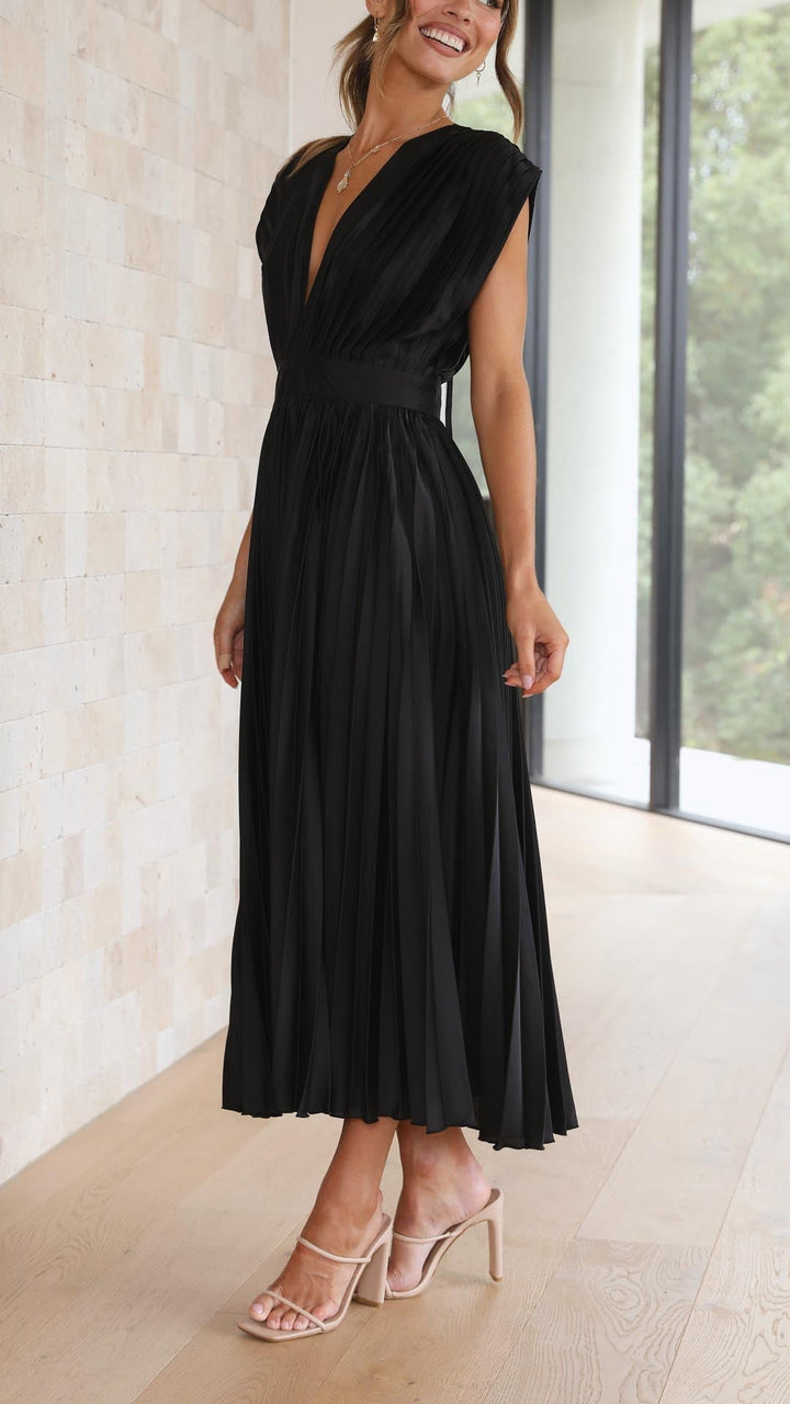 Silk pleated maxi dress with V-neck in rose red, featuring a high waist and elegant flowing pleats for a sophisticated look.
