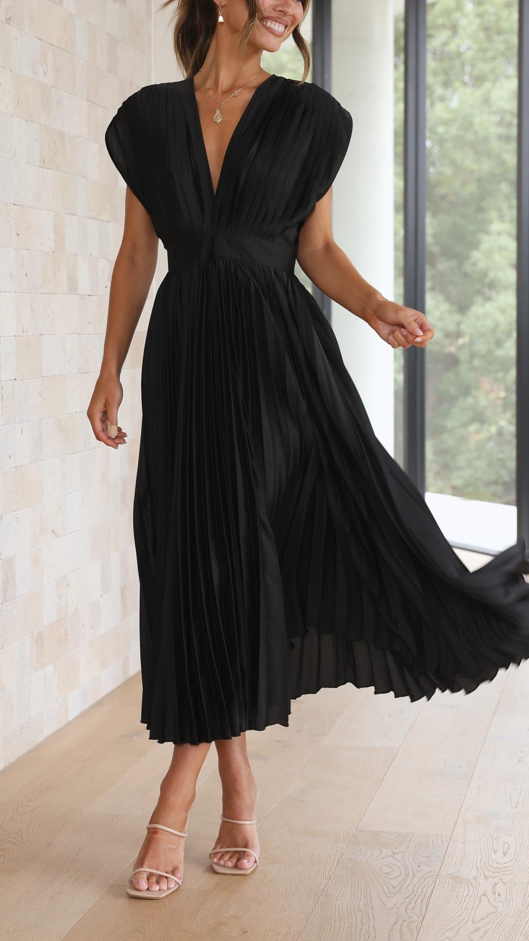 Silk pleated maxi dress with V-neck in rose red, featuring a high waist and elegant flowing pleats for a sophisticated look.