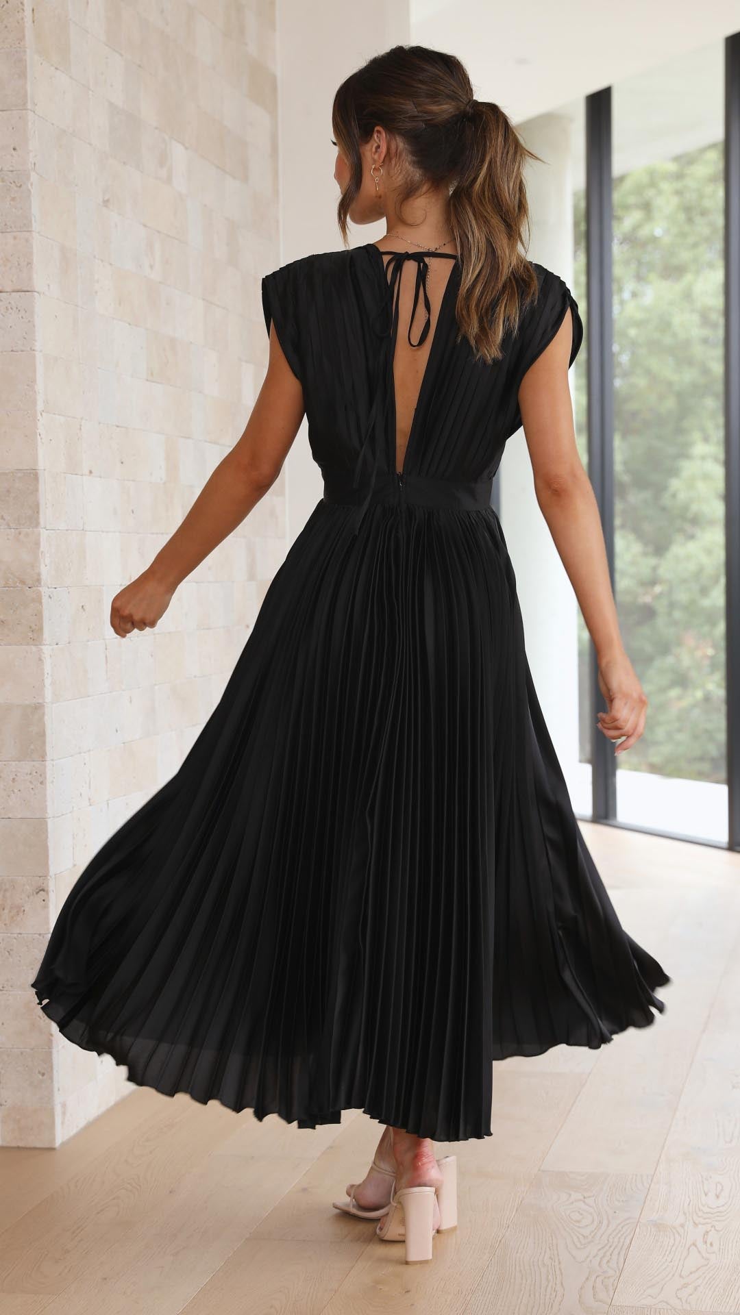 Silk pleated maxi dress with V-neck in rose red, featuring a high waist and elegant flowing pleats for a sophisticated look.