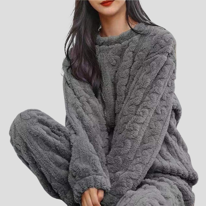 Women's plush fleece pajama set, including top & bottoms, designed for ultimate comfort and warmth at home.