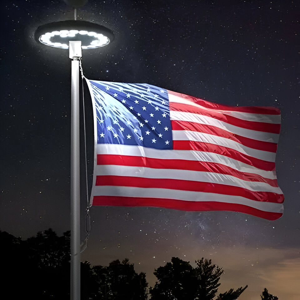 Solar LED light illuminates flagpole for continuous nighttime visibility, perfect for patriotic display.