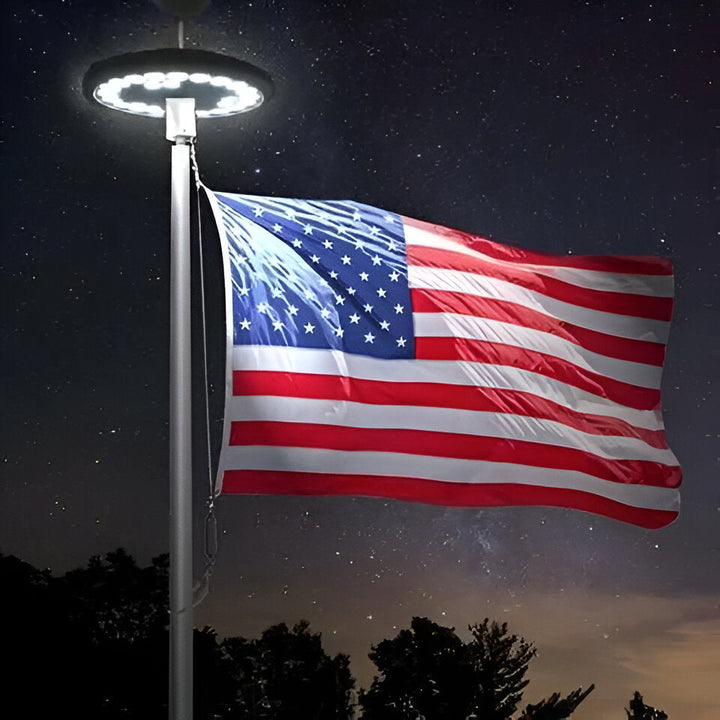 Solar LED light illuminates flagpole for continuous nighttime visibility, perfect for patriotic display.