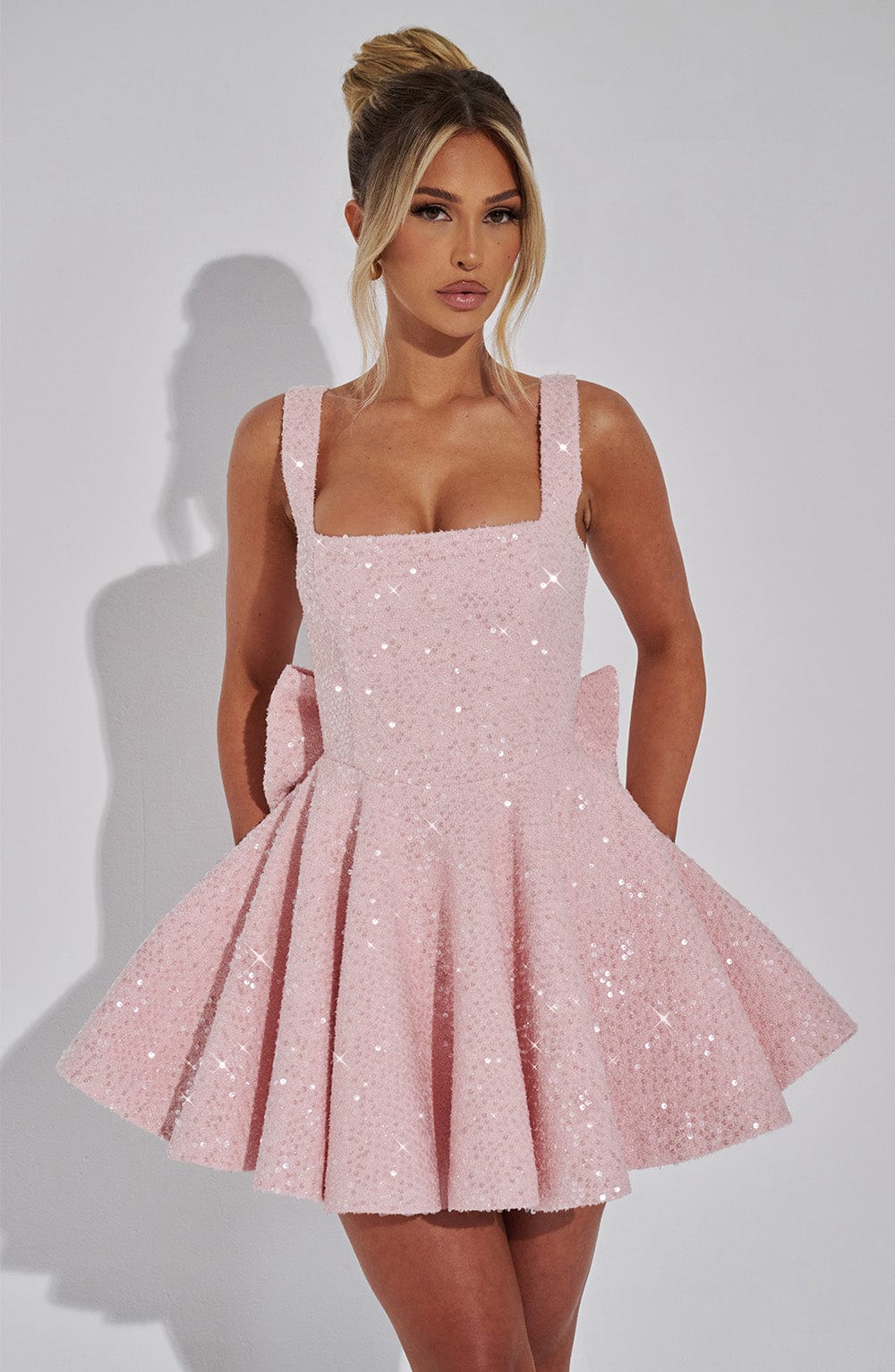 Sparkling backless bow mini dress for women. Glamorous party & evening wear, perfect for special occasions.