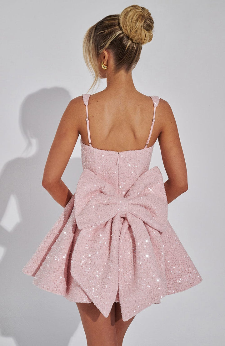 Women's glittering A-line mini dress with backless design & large bow accent. Ideal for cocktail parties.