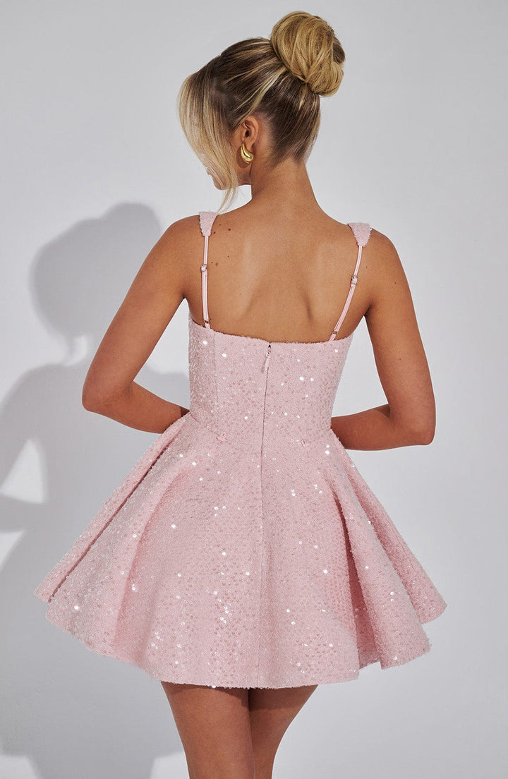 Shiny women's backless mini dress featuring a charming bow. Elegant A-line cut for glamorous evening wear.