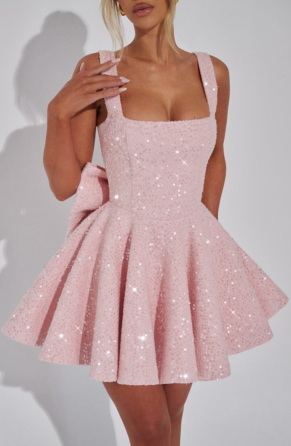 Women's sparkling backless mini dress with bow. Stylish evening & party dress for glamorous events.