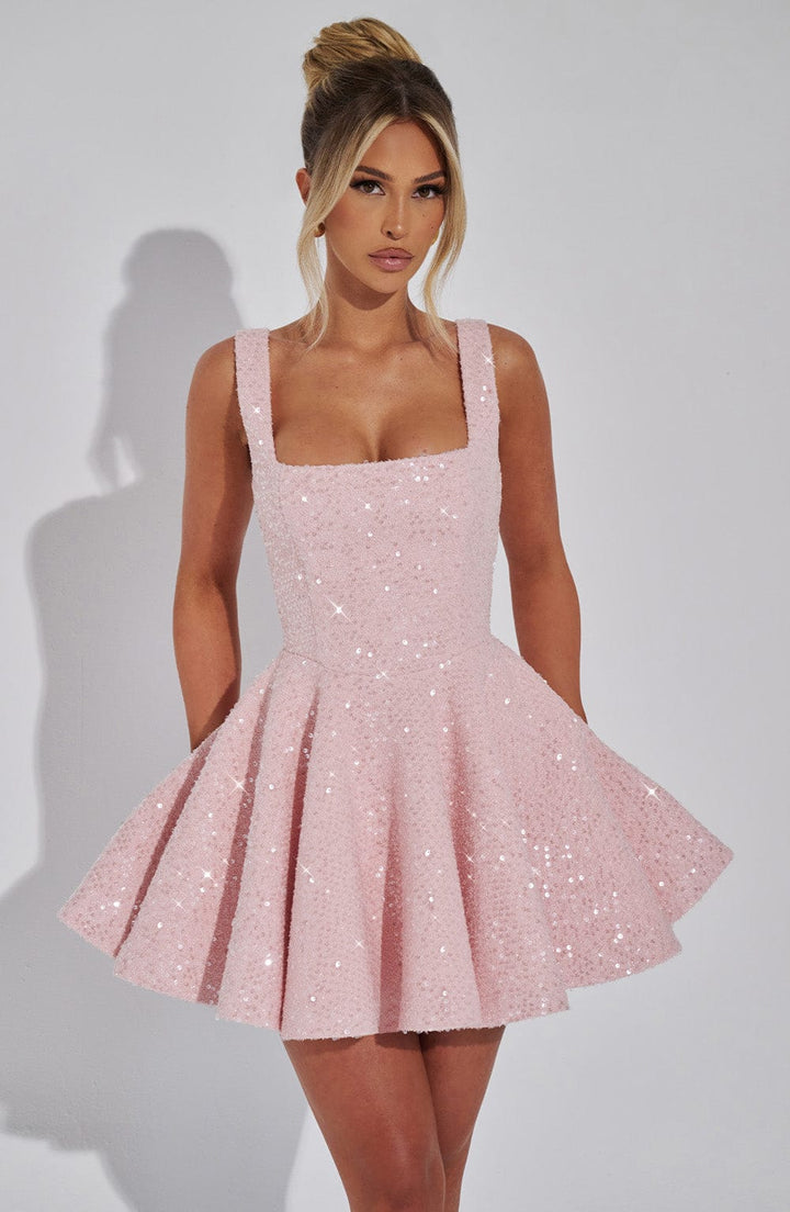 Glamorous women's evening mini dress, sparkling fabric, backless design & elegant bow detail.